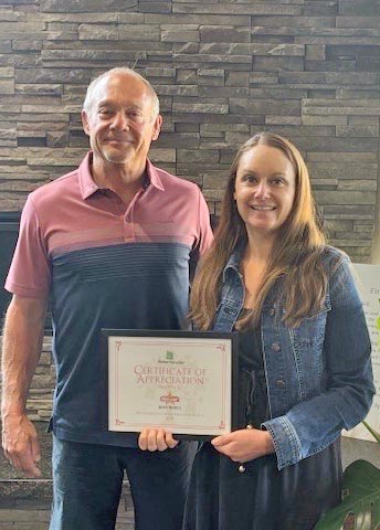 Star Body Works staff holding certificate of appreciation for sponsoring Medford Food Project